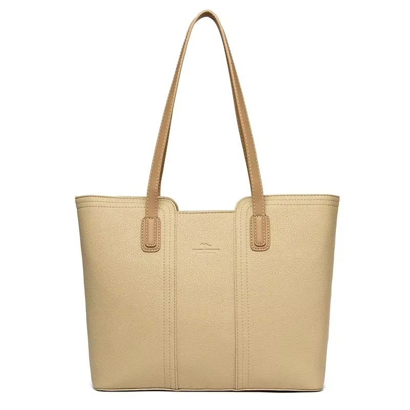 Elegant beige shopperväska dam med långa handtag. Rymlig design, slitstarkt PU-läder och praktiska fack. Perfekt för vardag och arbete.